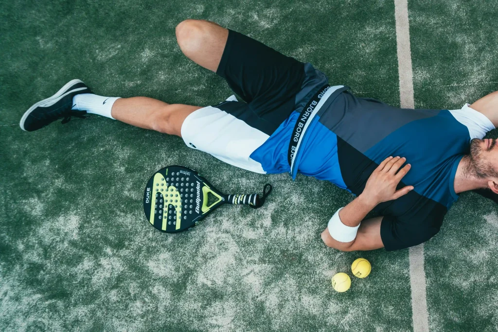 Athlete on an outdoor court after a possible leg injury