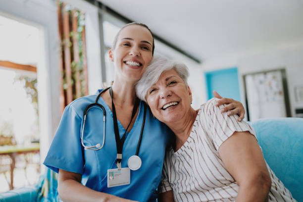 female Doctor hugging female old patient