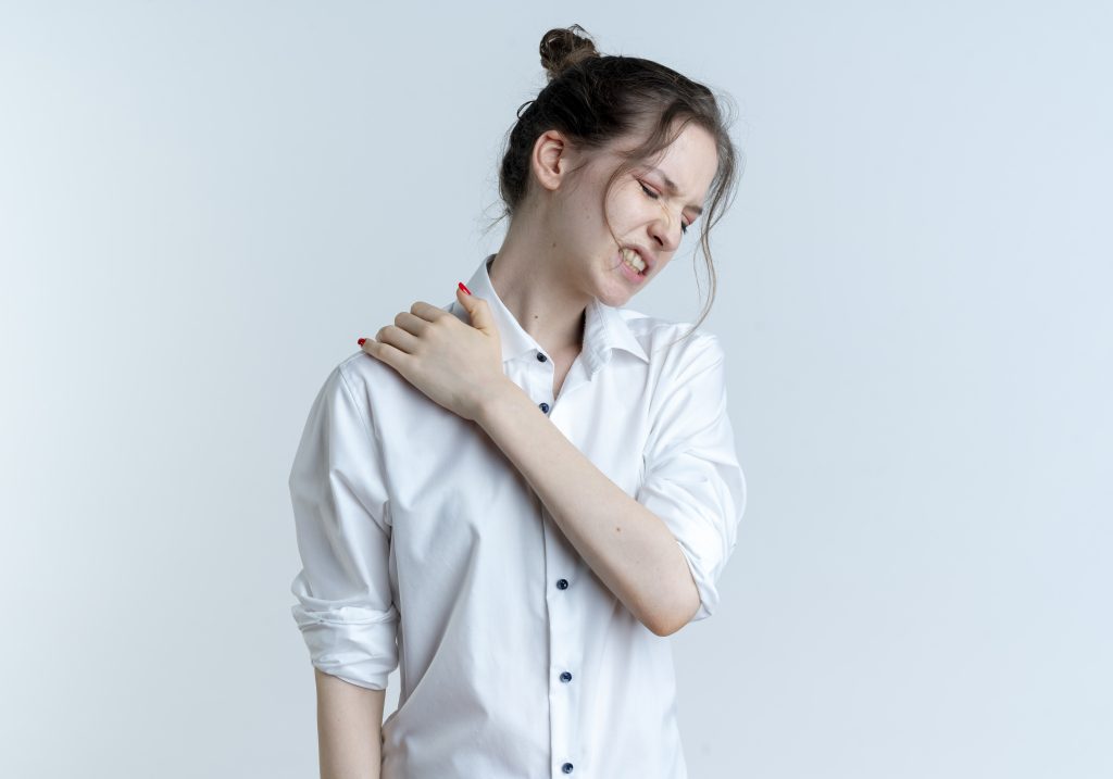young girl having shoulder pain at a white space